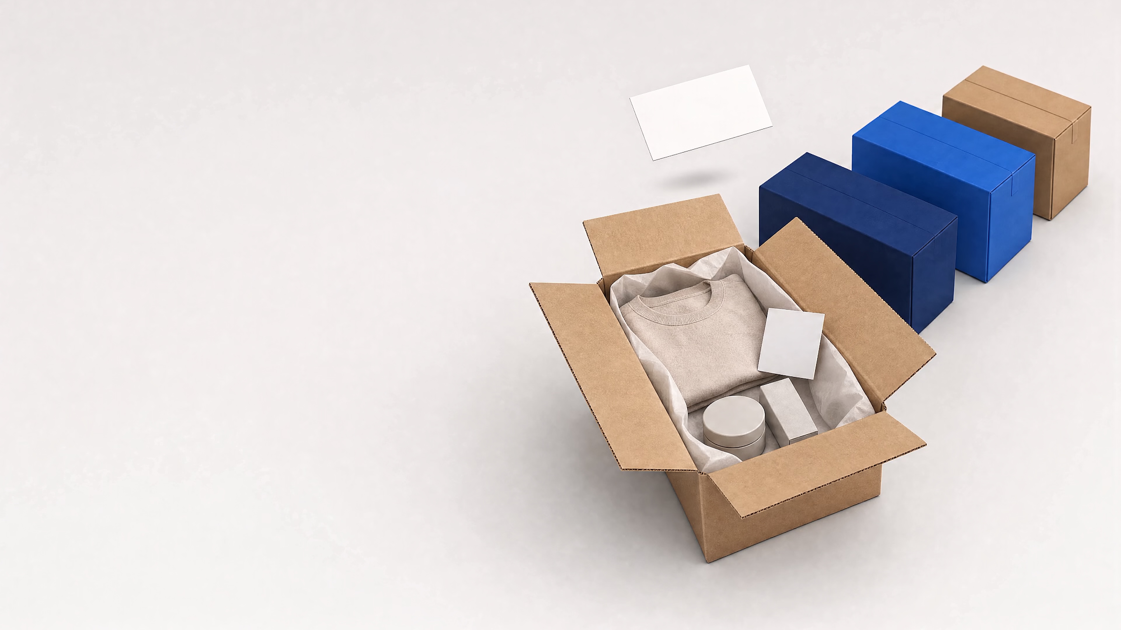 An open shipping carton packed with a folded garment, a jar and a boxed item on tissue paper, with an insert card and a blank label above it, and three sealed parcels in different colours behind